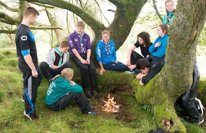 scouts and explorers around campfire